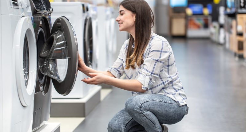 A,Young,Woman,In,A,Store,Chooses,A,Washing,Machine..